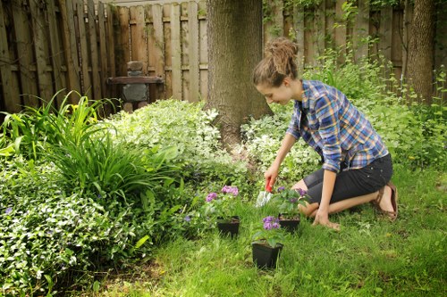 Crew wearing PPE and checking equipment before starting a garden maintenance job